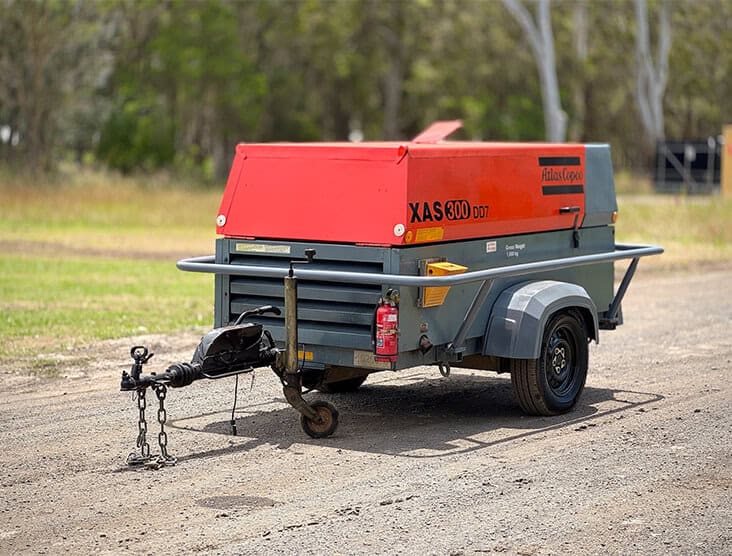 Portable air compressor on trailer for construction and industrial use.