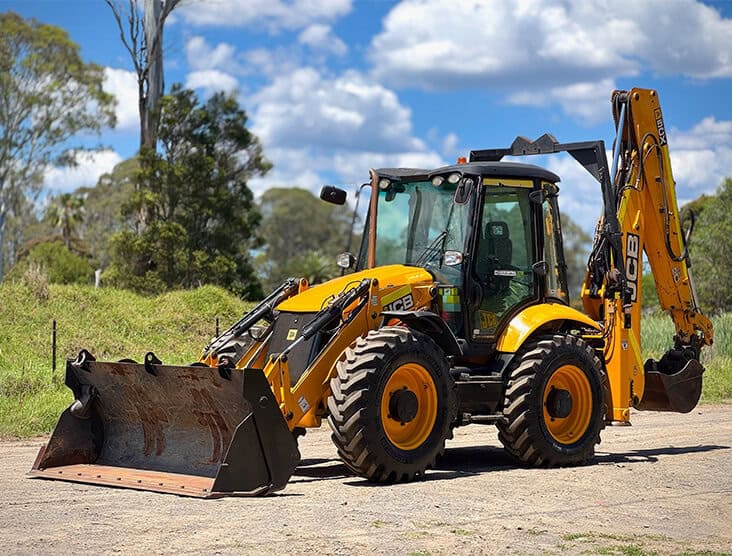 Excavator with backhoe attachment for construction and earthmoving projects.