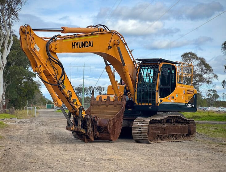 Hyundai excavator on construction site, heavy machinery for earthmoving.