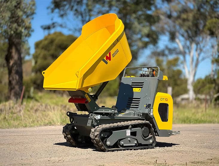 Mini dumper with yellow skip and tracked base for construction work.