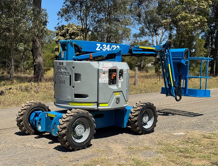 Telehandler with extendable boom and sturdy tires for lifting and moving heavy loads.