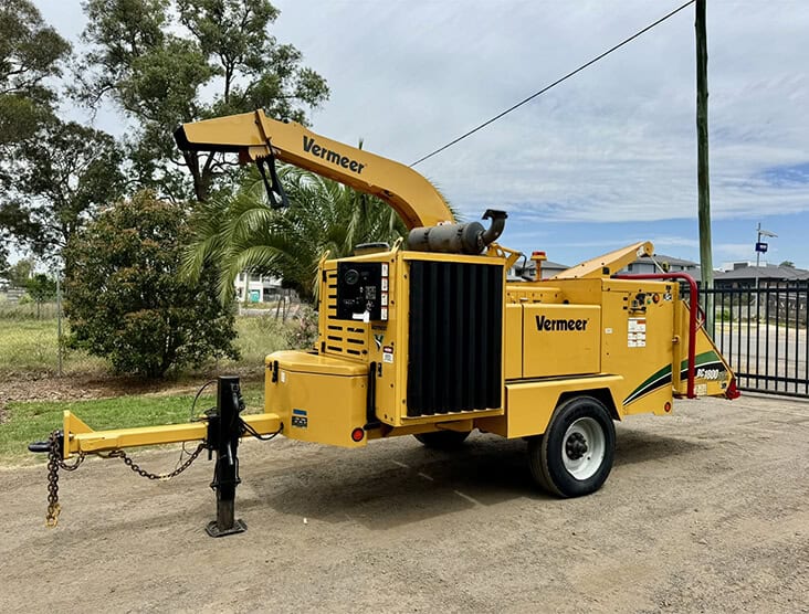 Vermeer wood chipper for efficient tree debris processing and mulch production.